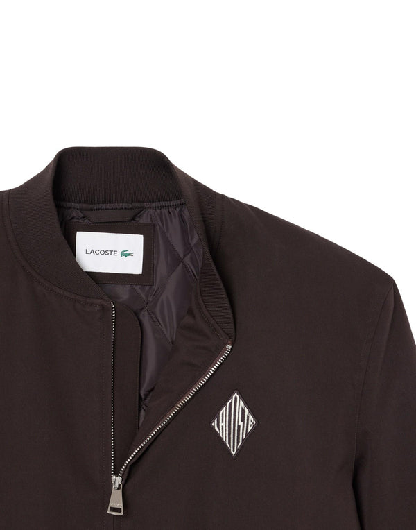 Lacoste Bomber impermeabile con stemma rétro Giubbotto uomo marrone immagine 2
